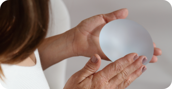 Motiva® Preservé™ 7 a person holding a plastic breast implant