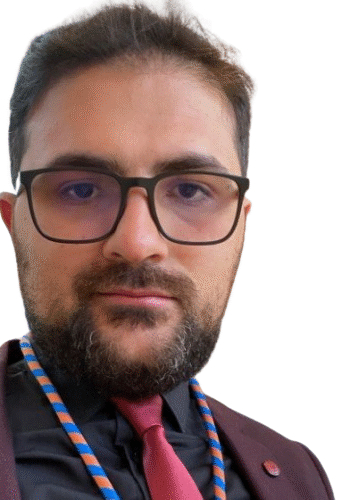 Dr. Arkaz Coskun in formal attire with tie.