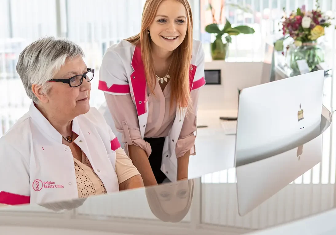 a woman and a woman looking at a computer
